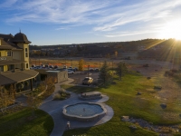 Springs Resort exterior with sun shining in the background