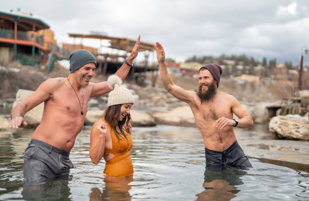 Friends celebrating together in the mineral pools at The Springs Resort