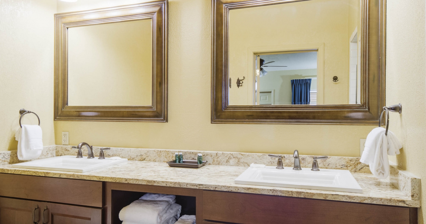 Double sink bathroom countertop with twin mirrors and lighting