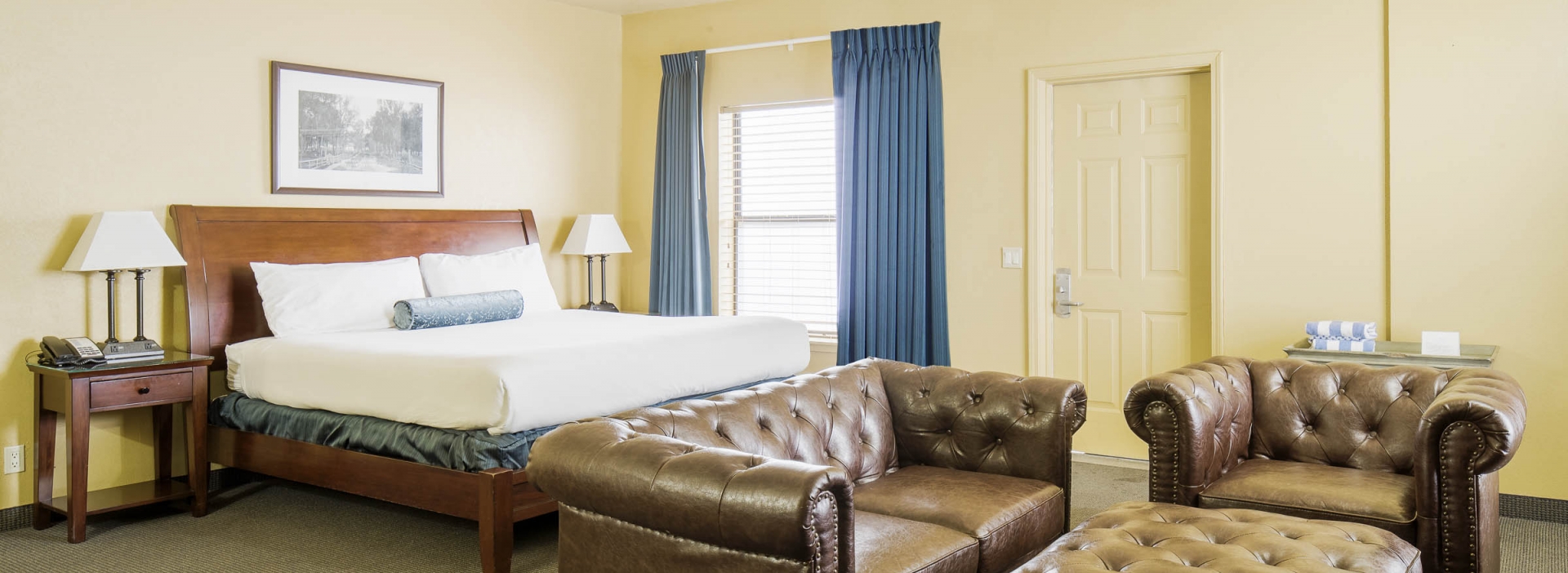 The bed behind the sofas and the ottoman in the Quien Sabe room