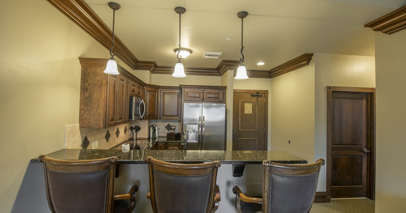The Kitchen bar counter top next to the kitchen area