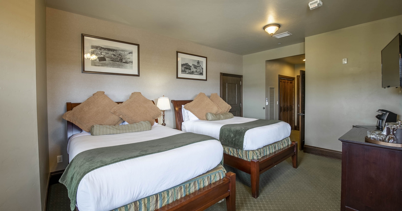 Wide shot of the second bedroom with twin beds in the Condo suite