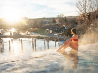 Woman sitting on the edge of pool watching the view