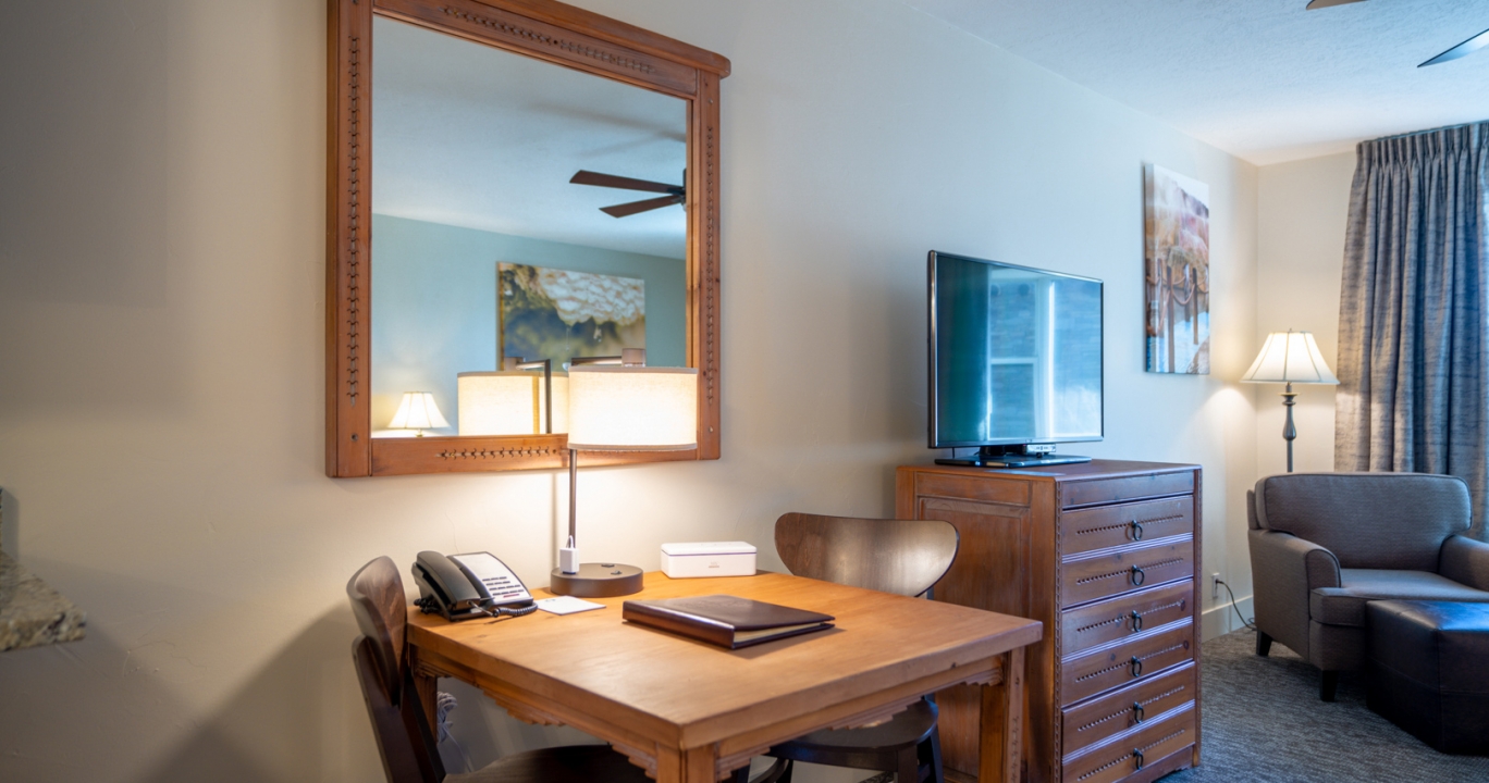 A wooden table for two in the Deluxe living room