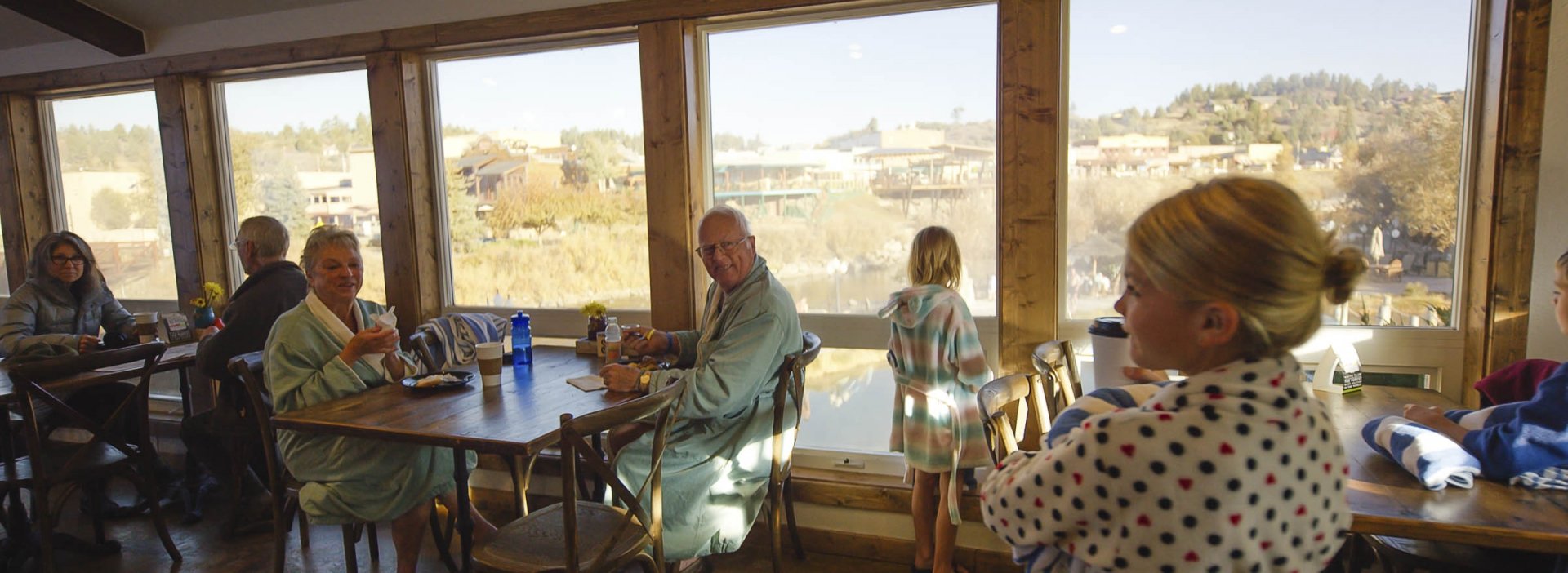 An elderly couple looking at child holding a towel
