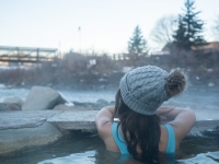 Woman soaking in a hot spring in winter