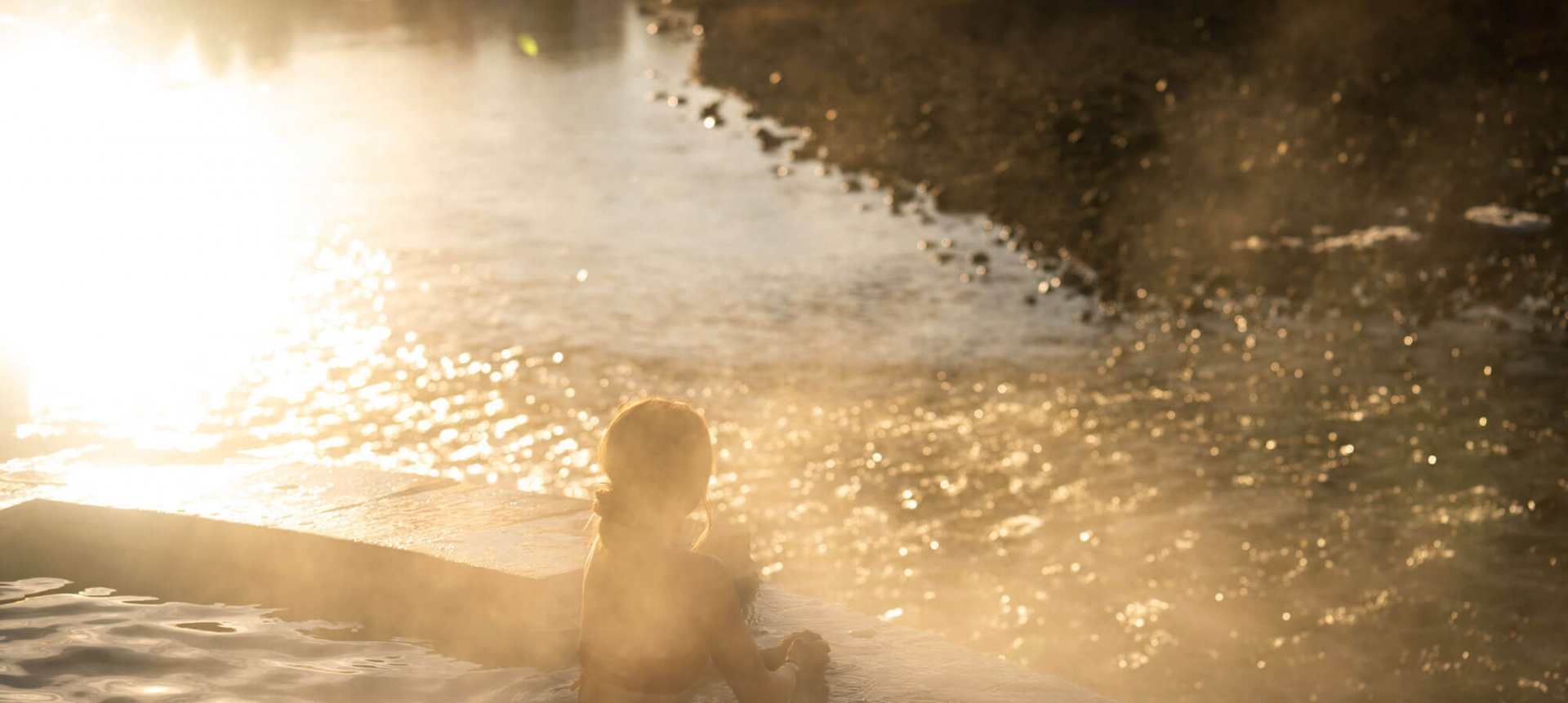 Young woman soaking at sunset