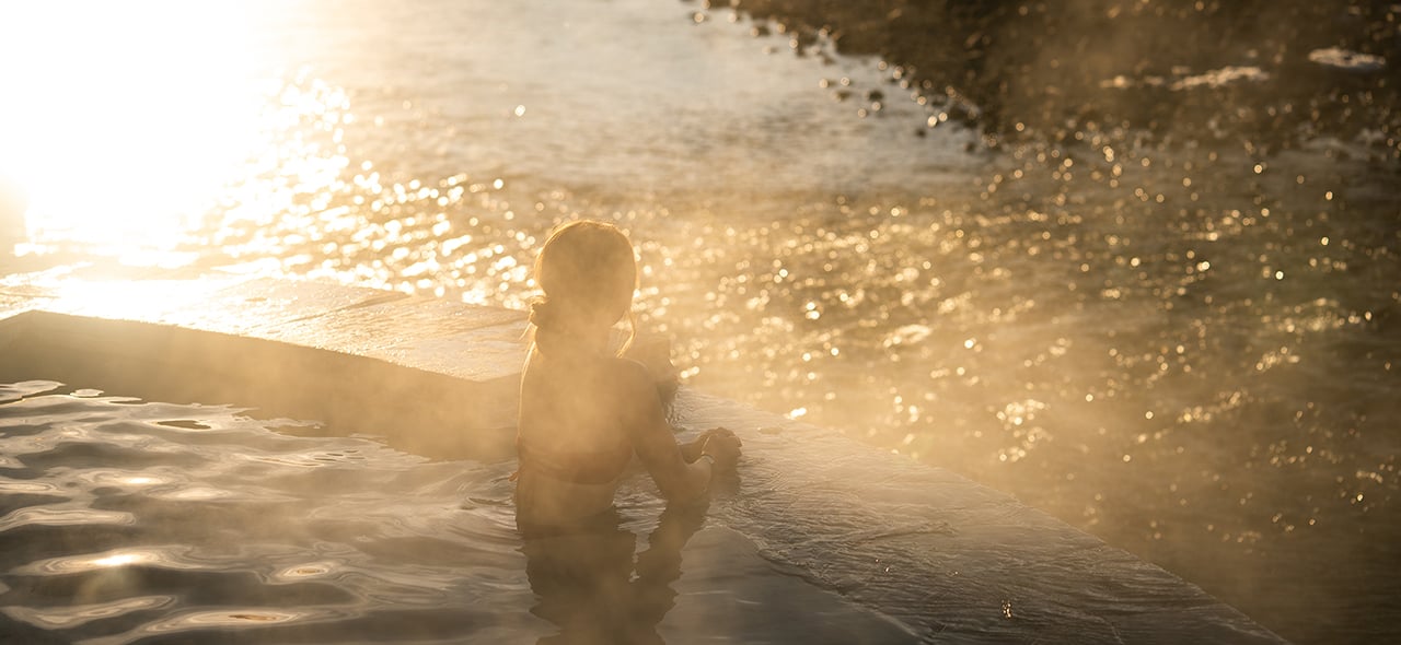 Women overlooking the river from hot springs pool