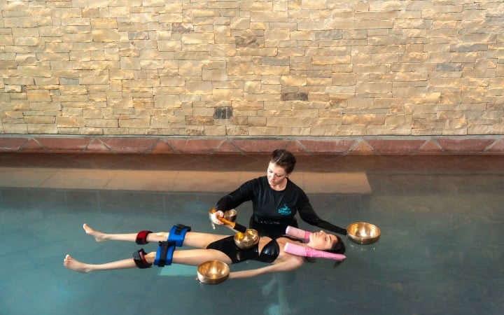 Relaxing aqua therapy session at The Springs Resort's pool with a therapist.