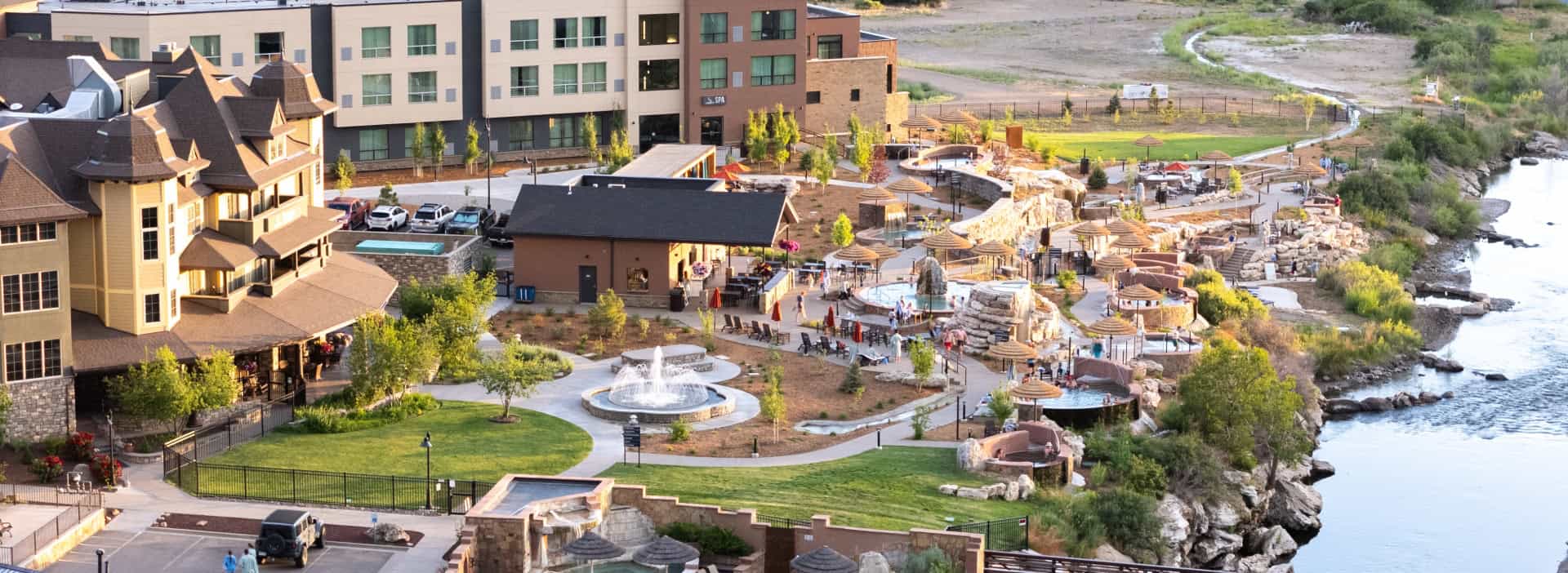 Aerial view of The Springs Resort with hot springs pools and surrounding landscape in Pagosa Springs.