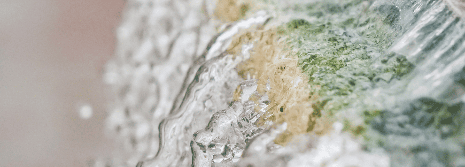 Close-up of mineral-rich water flowing over rocks at The Springs Resort in Pagosa Springs.