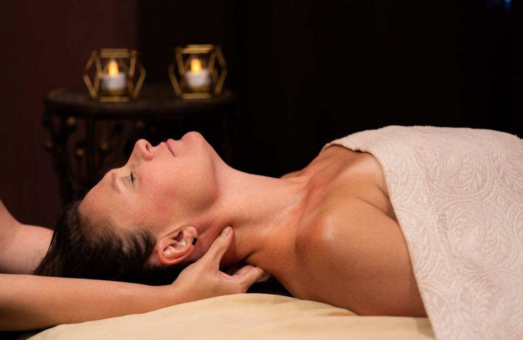 Woman receiving a hot stone massage in a spa setting at The Springs Resort, Pagosa Springs, Colorado.