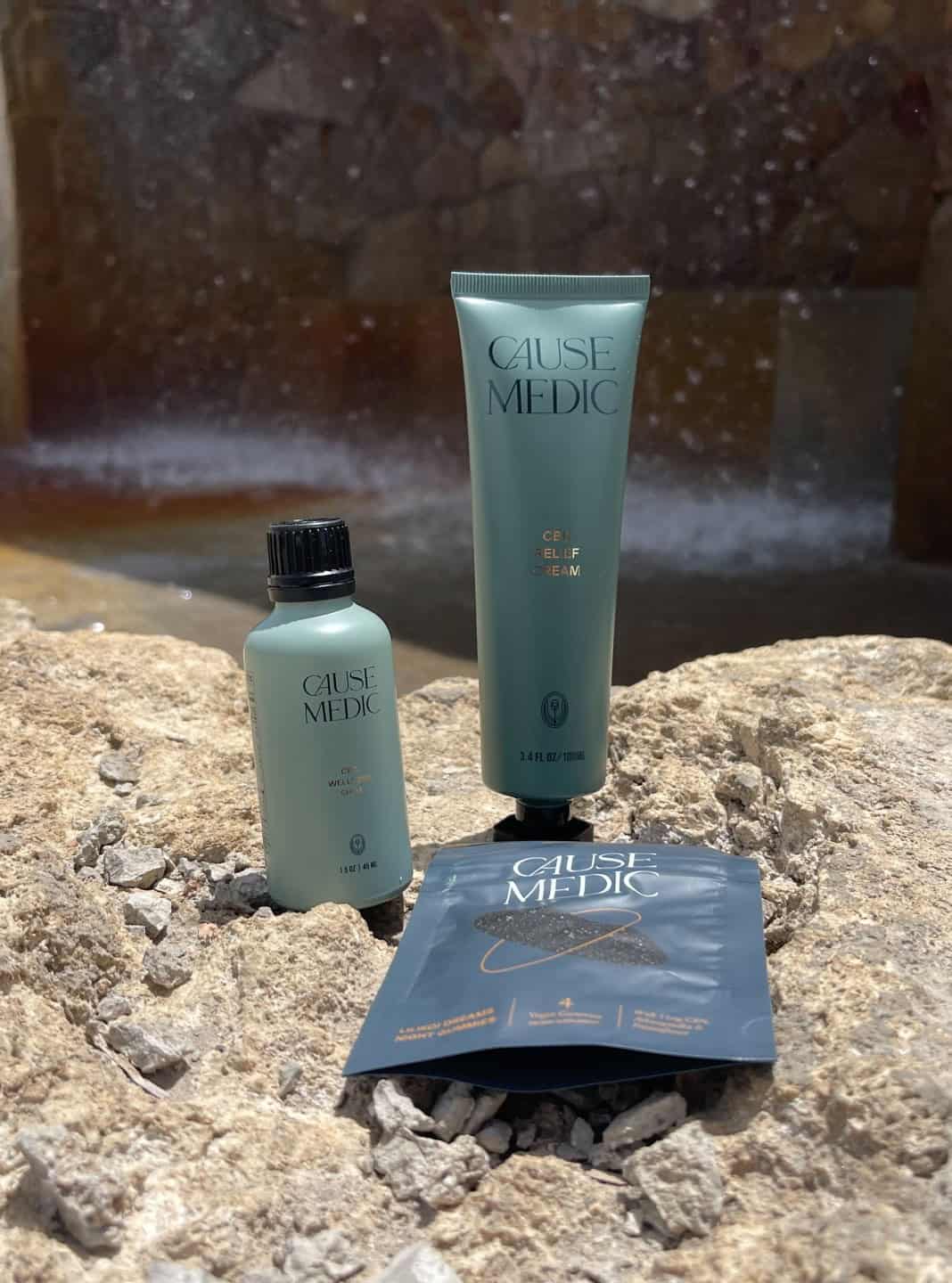 Cause Medic skincare products on rocks near hot spring water at The Springs Resort.